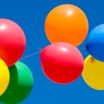 Birthday Balloons in a Row Against Blue Sky