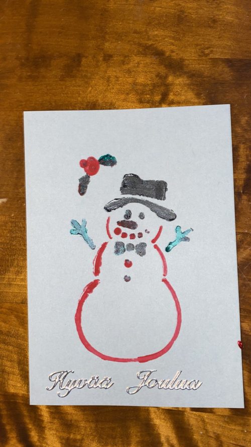 Kortissa on hymyilevä lumiukko ja lukee Hyvää joulua!